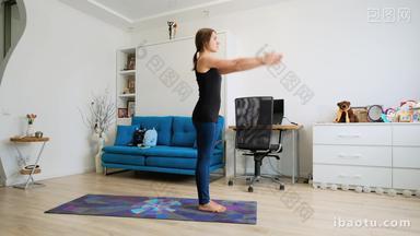 Young woman practicing yoga at home warming up