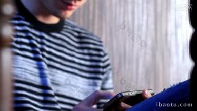年轻的成年男子使用和玩触摸屏<strong>手机</strong>