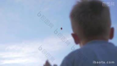 一个小男孩向高空的天灯<strong>挥手</strong>的低角度镜头