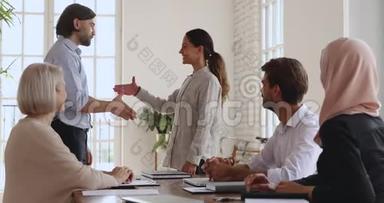 骄傲的公司经理握手称赞快乐的女员工