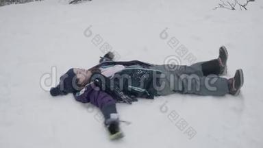 一个年轻的女孩躺在雪地里移动她的胳膊和腿，做一个雪天使