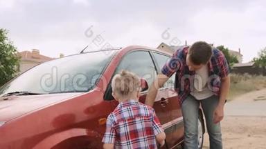 年轻的父亲示范如何清洁和清洗汽车`门给他聪明的儿子慢动作