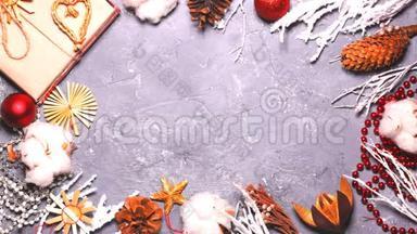 新年平躺的延时视频.. 珠子，玩具，树枝，雪，锥，红色球在灰色背景，顶部视图。