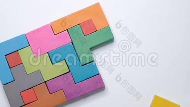 特写慢动作.. 手持一块木块拼图.. 木立方体堆叠。 复杂而聪明的逻辑概念