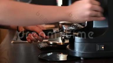 一个女人倒咖啡豆在咖啡机里做卡布奇诺。 咖啡师手准备<strong>补品</strong>的详细计划