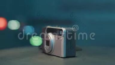 旋转相机正在桌子上显示旧的灰色半自动胶片照片相机..