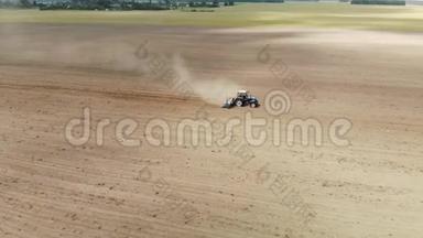 一个农民在蓝色拖拉机上，带着播种机在干燥的沙质土壤中播种