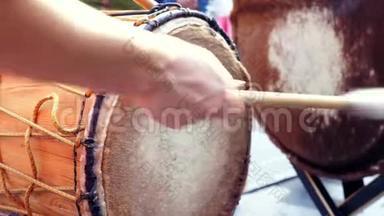 在阳光明媚的夏天，音乐家们用手演奏非洲舞鼓