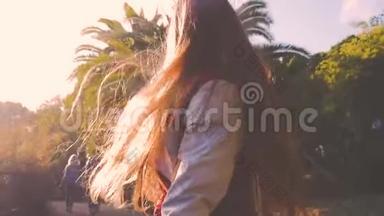 快乐的少女在棕榈树附近跳舞。 大气复古日落的样子.. 复古风格视频