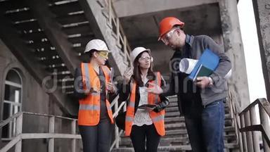 工头和两名女视察员讨论建造或恢复建筑的工作计划