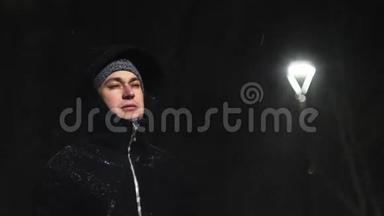 街灯里的那个人。 `在灯的背景下下雪。 在180fps内缓慢运动.. 雪花真美