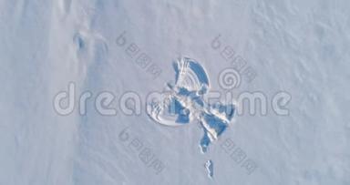 <strong>雪天</strong>使`在白雪覆盖的区域打印。 空中镜头。 相机在旋转。