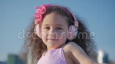 一个卷发可爱的孩子的肖像，一个穿着<strong>粉色</strong>衣服穿着<strong>粉色</strong>花朵的白种人小女孩的夏天