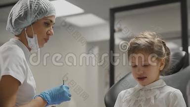 牙医检查牙套一个小女孩，检查牙齿是否有龋齿。 牙医`办公室。