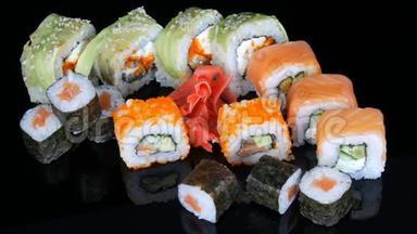 各种彩色寿司卷集和生姜在镜面上的黑色<strong>背景</strong>。 日本<strong>料理</strong>工作室