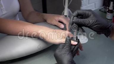 美甲师在美甲沙龙里为下一次修脚准备指甲，画一个特殊的指甲