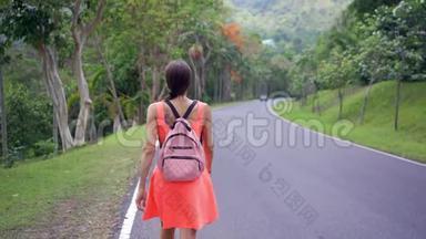 美丽的<strong>雨林</strong>与一位年轻的女旅行者在进入泰国森林的道路上。 女人在<strong>雨林</strong>里散步