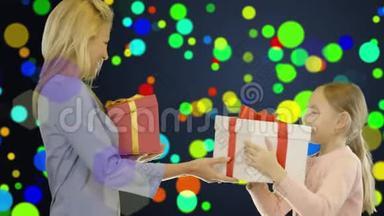 一个女孩和一个年轻的女人用盒子互相送礼物。 喜庆多彩的背景，像纸屑..