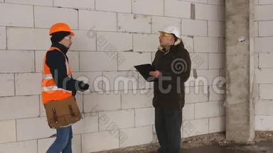 工程师和工长在施工现场冬季，讨论文件到施工现场。