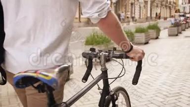 欧洲小镇老街上，一位年轻<strong>时尚男士</strong>骑着固定齿轮的运动自行车行走