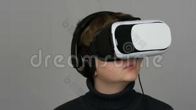青少年男孩看白色虚拟现实眼镜或虚拟现实，并在工作室的白色背景上玩得很开心。 <strong>未来</strong>是