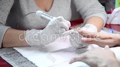 专业修甲工艺，在美容师沙龙用修甲铣刀清洗指甲。
