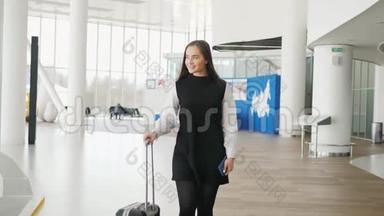 女游客在<strong>国际</strong>机场航<strong>站</strong>楼携带行李使用智能手机。 语音识别短信命令