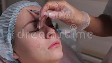 医生在中年妇女前额眉间注射面部提升注射以消除面部皱纹。