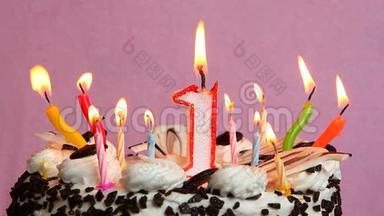 <strong>一周年</strong>纪念日，蛋糕和蜡烛放在粉红色<strong>背景</strong>上