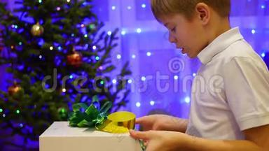 圣诞<strong>礼物惊喜</strong>-一个孩子打开<strong>礼物</strong>。 背景中，bokeh灯和花环..
