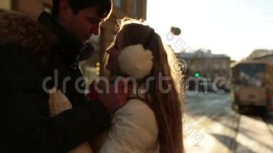 快乐的年轻夫妇在冬天的日落时<strong>轻轻地</strong>接吻。 城市生活和交通堵塞背景