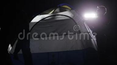 两名成年男子和儿童从越野车上<strong>搭帐篷</strong>的夜间镜头。