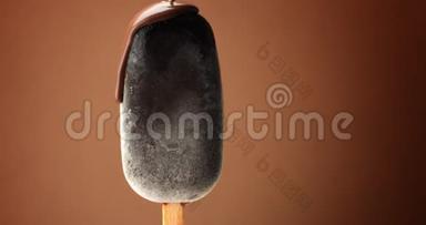 巧克力冰淇淋在棍子上，液体巧克力覆盖它。 不同的巧克力质地