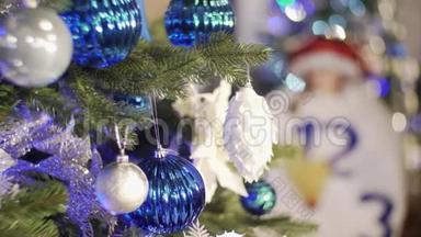 圣诞树上装饰着明亮的蓝色花环和玩具。 圣诞树上装饰着明亮的蓝色花环和玩具