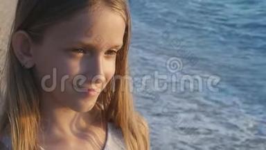 日落时在海滩上玩耍的孩子，看海浪的孩子，岸上的女孩肖像