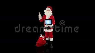 圣诞老人展示了一块空白平板电脑，与黑色的，库存的镜头