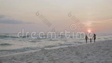 幸福的家庭和一个孩子在日落4k海滩度假