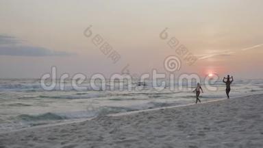 幸福的家庭和一个孩子在日落4k海滩度假