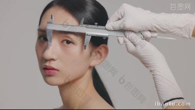 整形医生测量女人面部尺子平滑的实拍素材