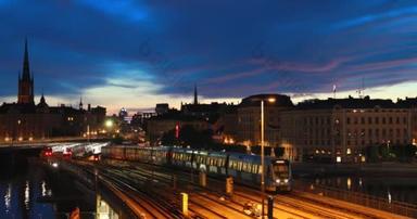 瑞典斯德哥尔摩。地铁列车在夜间运行.城市天际线。4K