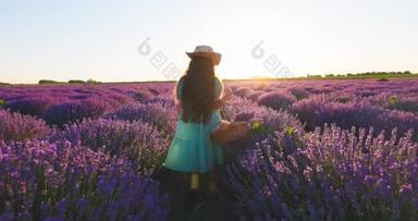 Happy girl with farming dress enjoying lavender field with bouquet of flowers in basket during sunse