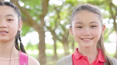 Portrait of happy asian young girl and  boy outside the primary school