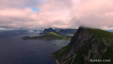在悬崖峭壁上挪威罗弗敦群岛由云飞行