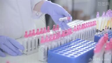 护士检查血液分析在现代的明亮实验室试管.