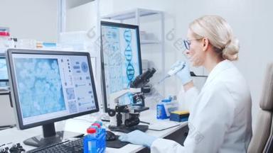 女<strong>科学家</strong>提取液体并用显微镜观察