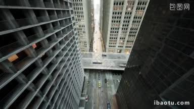 现代城市中心摩天大楼之间繁忙的汽车交通的空中空爆