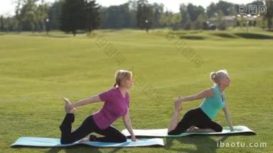 迷人的<strong>健身</strong>高级妇女<strong>做</strong>鸽子体式<strong>瑜伽</strong>运动在公园草坪上，而坐在运动垫美丽的成人适合