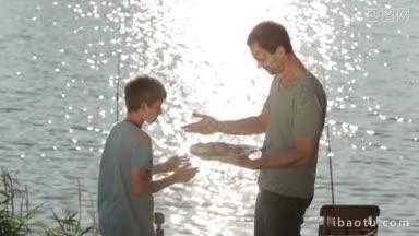 积极的父亲给他的儿子提供新鲜的炸鱼，鱼放在盘子里的格栅上，在美丽的湖背景