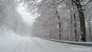 冬天，<strong>山上</strong>一条被雪覆盖的空旷道路的景色，道路两旁长满了树