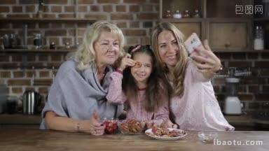 微笑的多代家庭在厨房用<strong>手机</strong>自拍可爱的小女孩和漂亮的妈妈和可爱